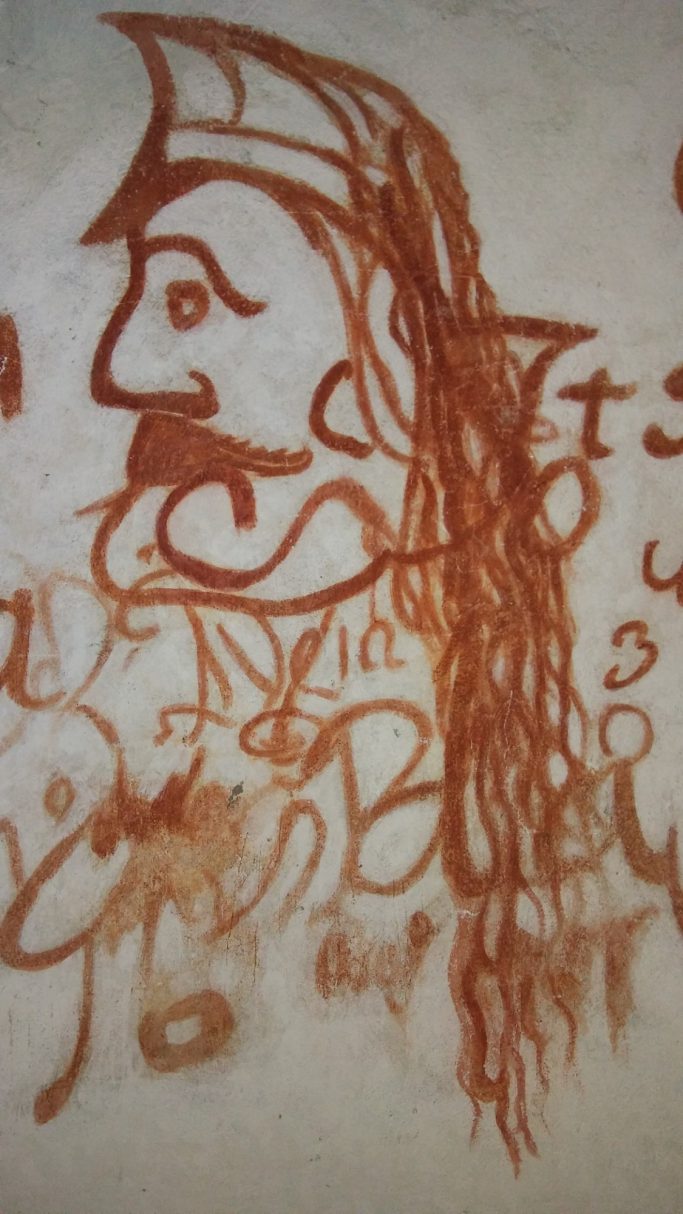 Dibujo en tonos marrones de un personaje con barba y un sombrero, con detalles estilizados.